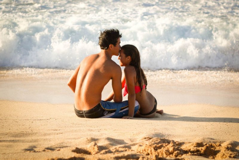 A guy with a girl on the beach
