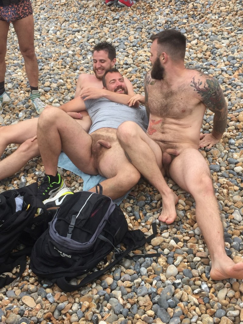 A naked guy lies on the beach