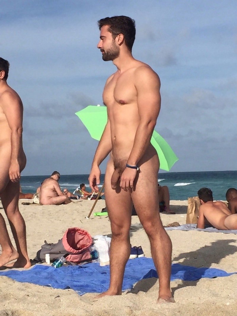A guy with a huge member on the beach