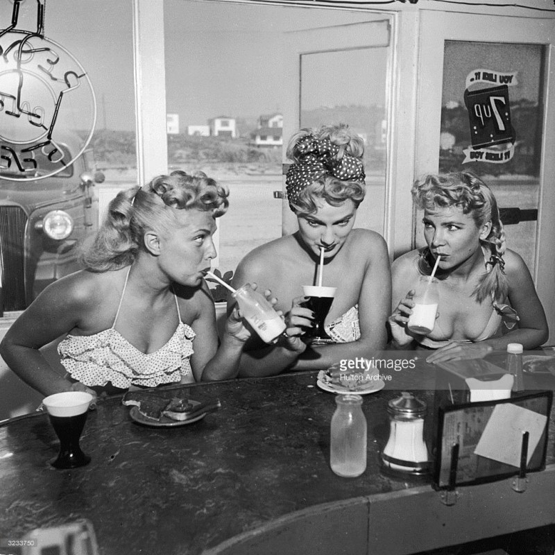 A retro picture of a woman drinks