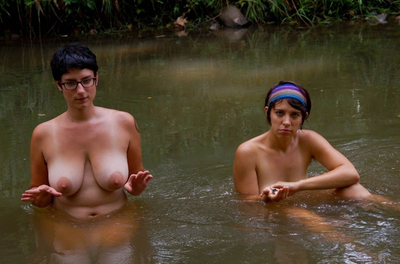 Naked women bathe in the river